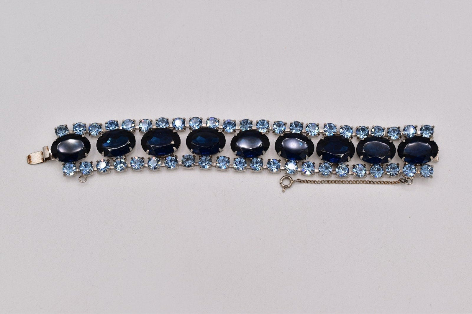 Bracelet with blue and black gemstones on a light gray background