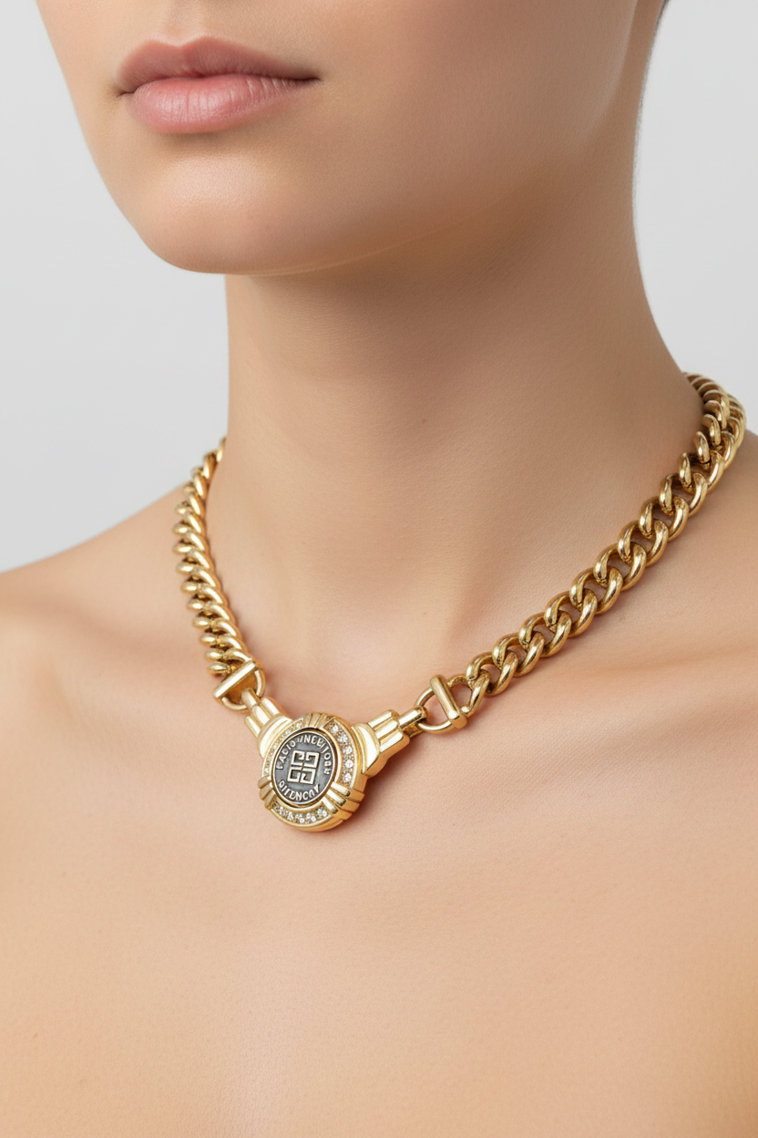 Gold chain necklace with Givenchy clasp on a black mannequin against a white background