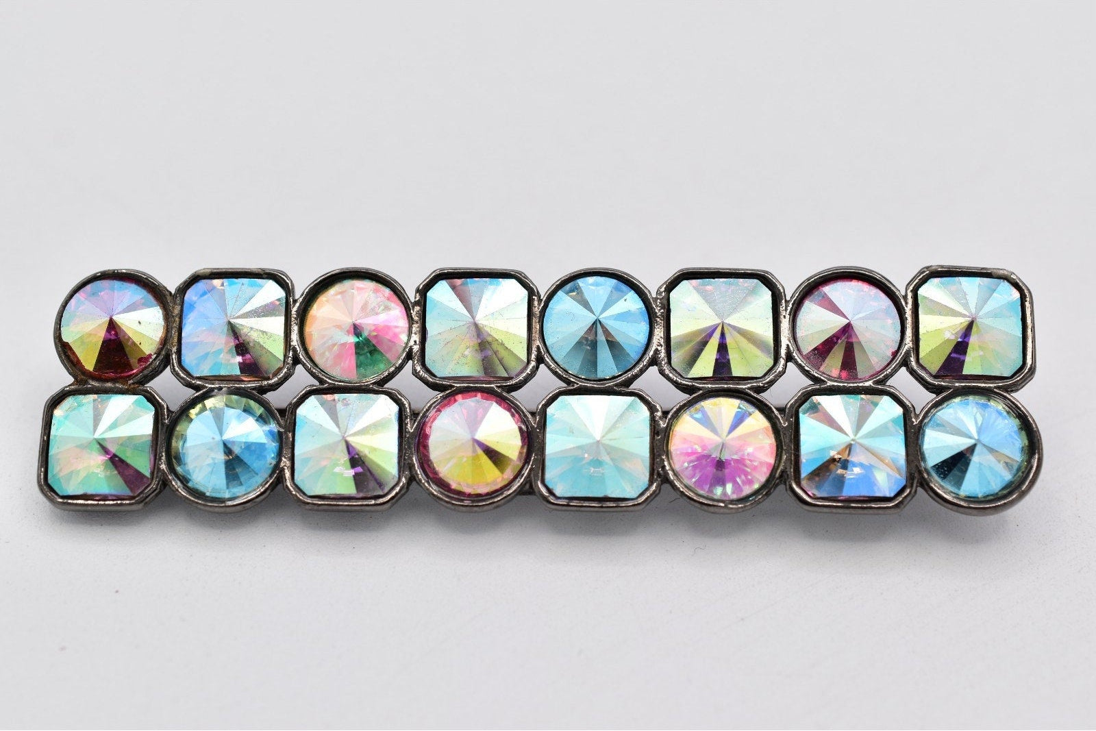 Multicolored gemstone barrette on a light gray background