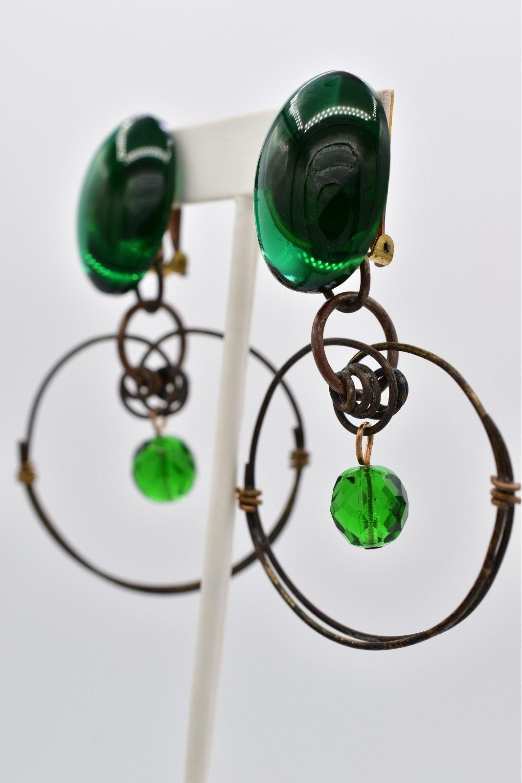 Pair of green glass earrings on a white background