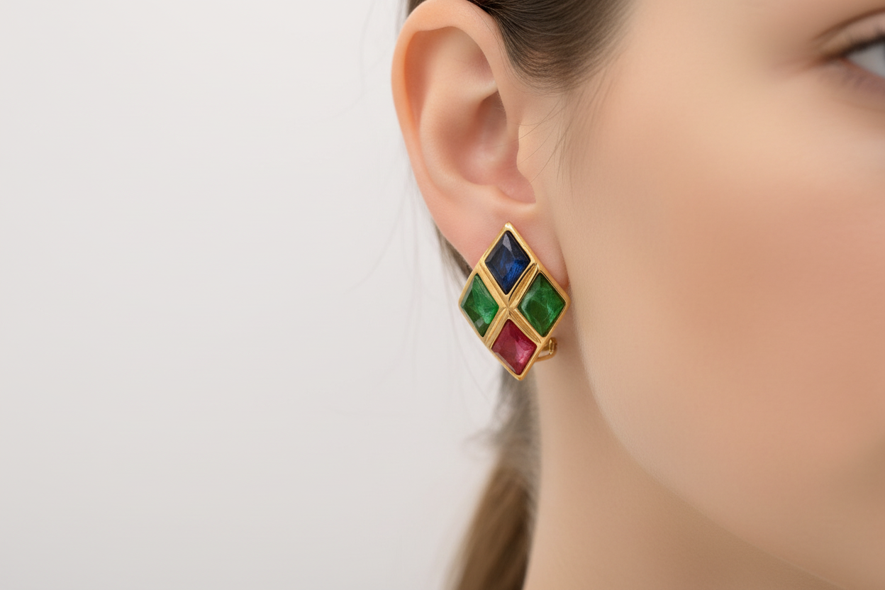 A pair of vintage Christian Dior clip-on earrings featuring vibrant multi-color diamond-shaped cabochons.
