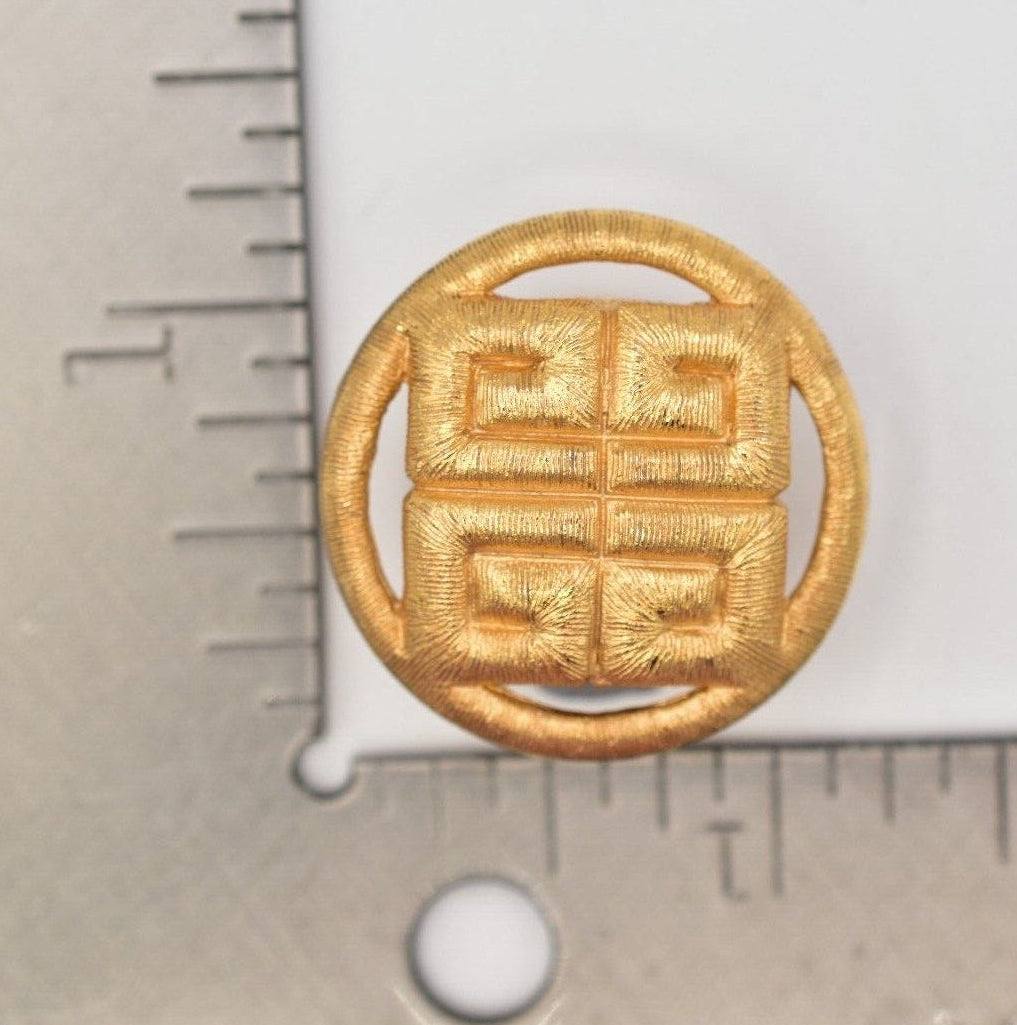 Gold earring with Chinese characters on a white background