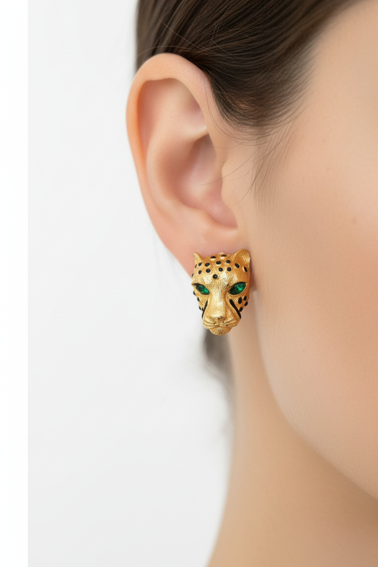 Gold leopard head charm on a ruler for scale