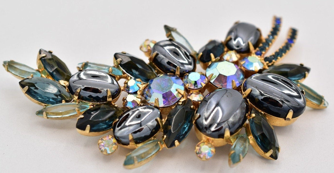 Decorative brooch with gemstones on a light gray background