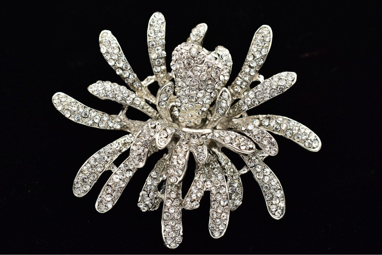 Decorative brooch with intricate design on a black background