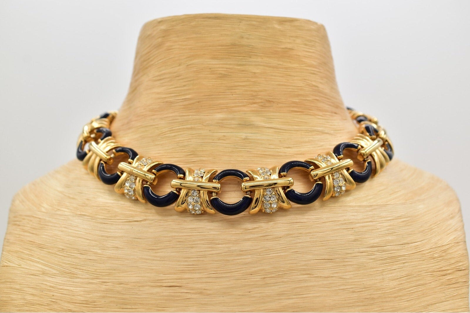 Gold and black chain necklace on a mannequin neck