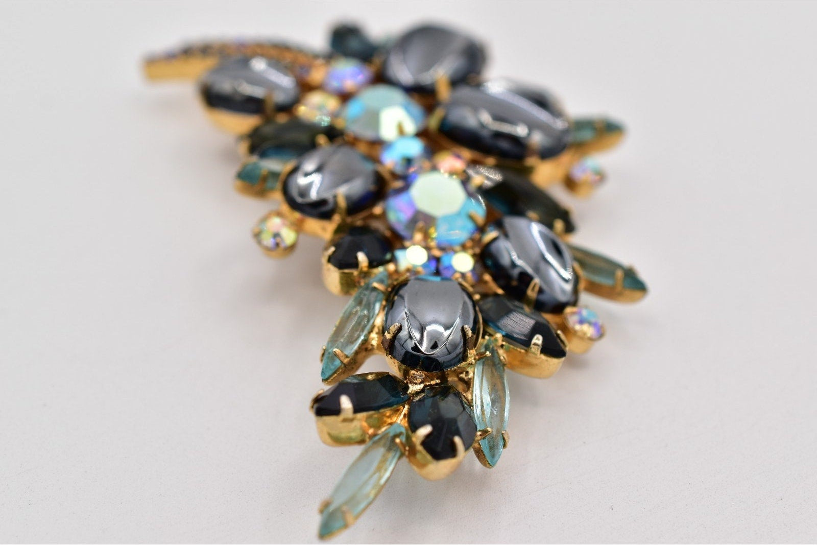 Jewelry piece with multicolored stones on a light gray background