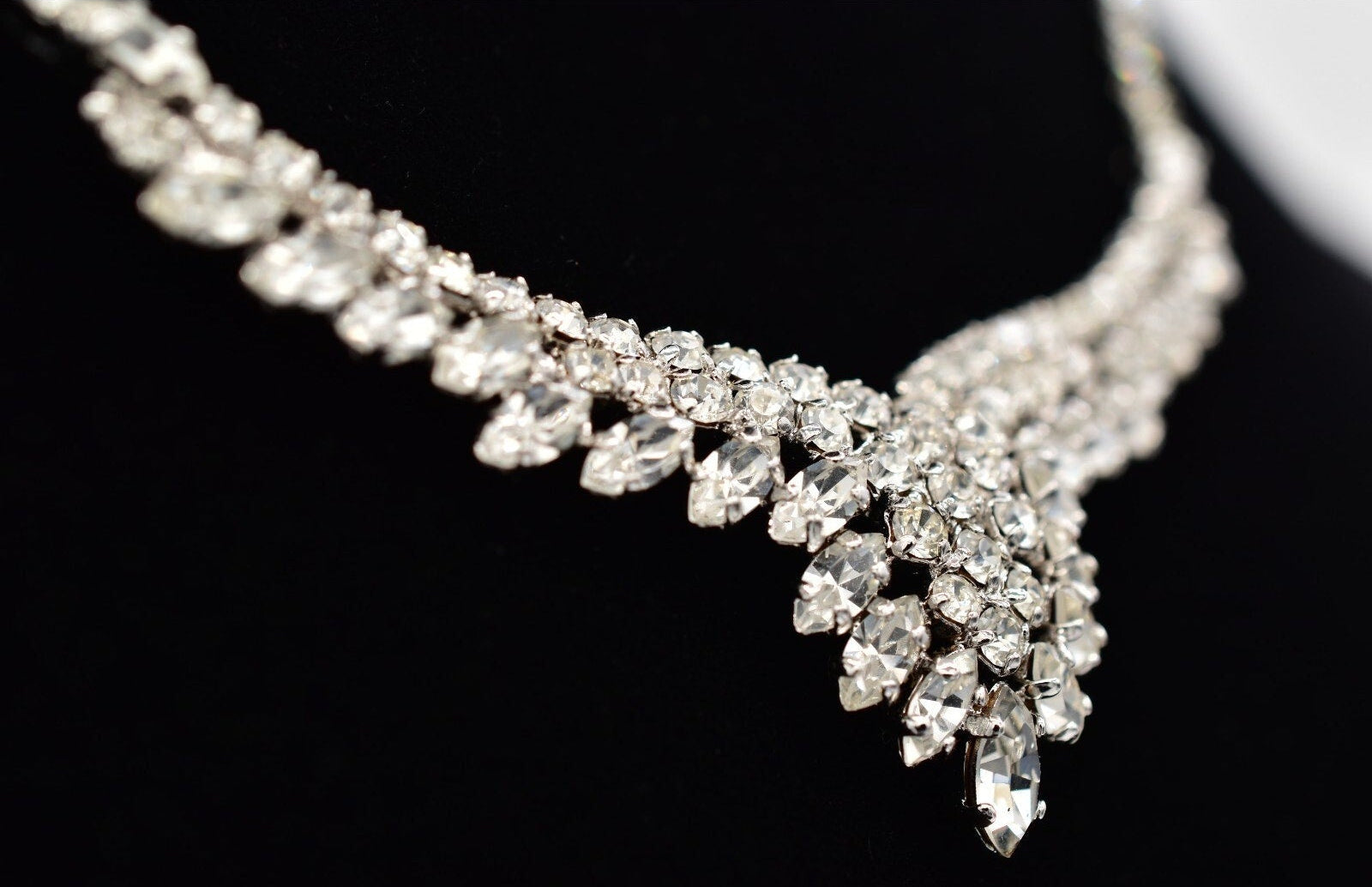 Christian Dior silver rhinestone necklace with clear gemstones on a black background