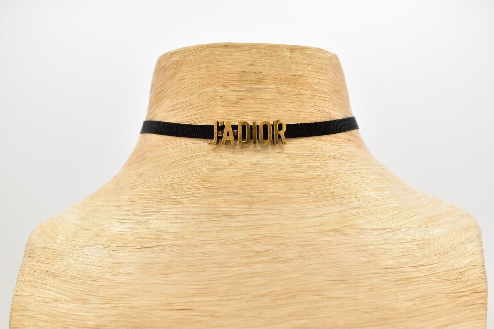 Wide-brimmed hat with a black band featuring 'J'ADIOR' on a white background