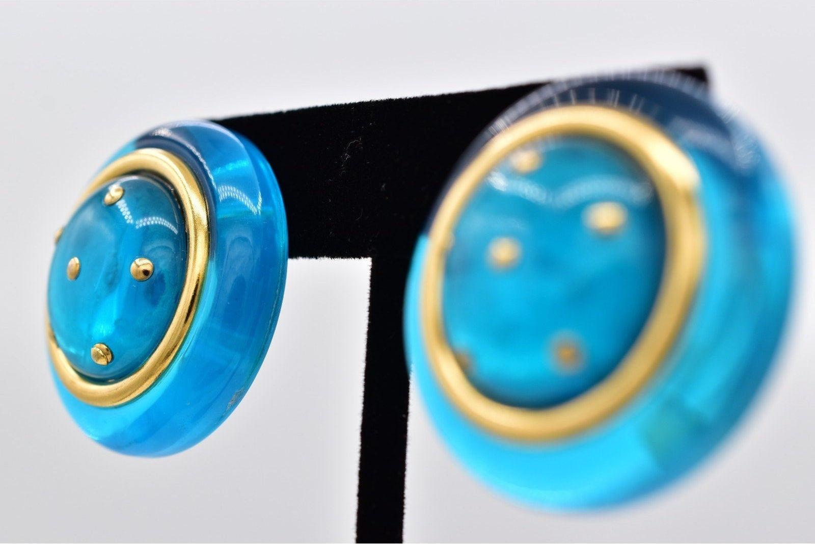 Blue earrings with gold accents on a white background