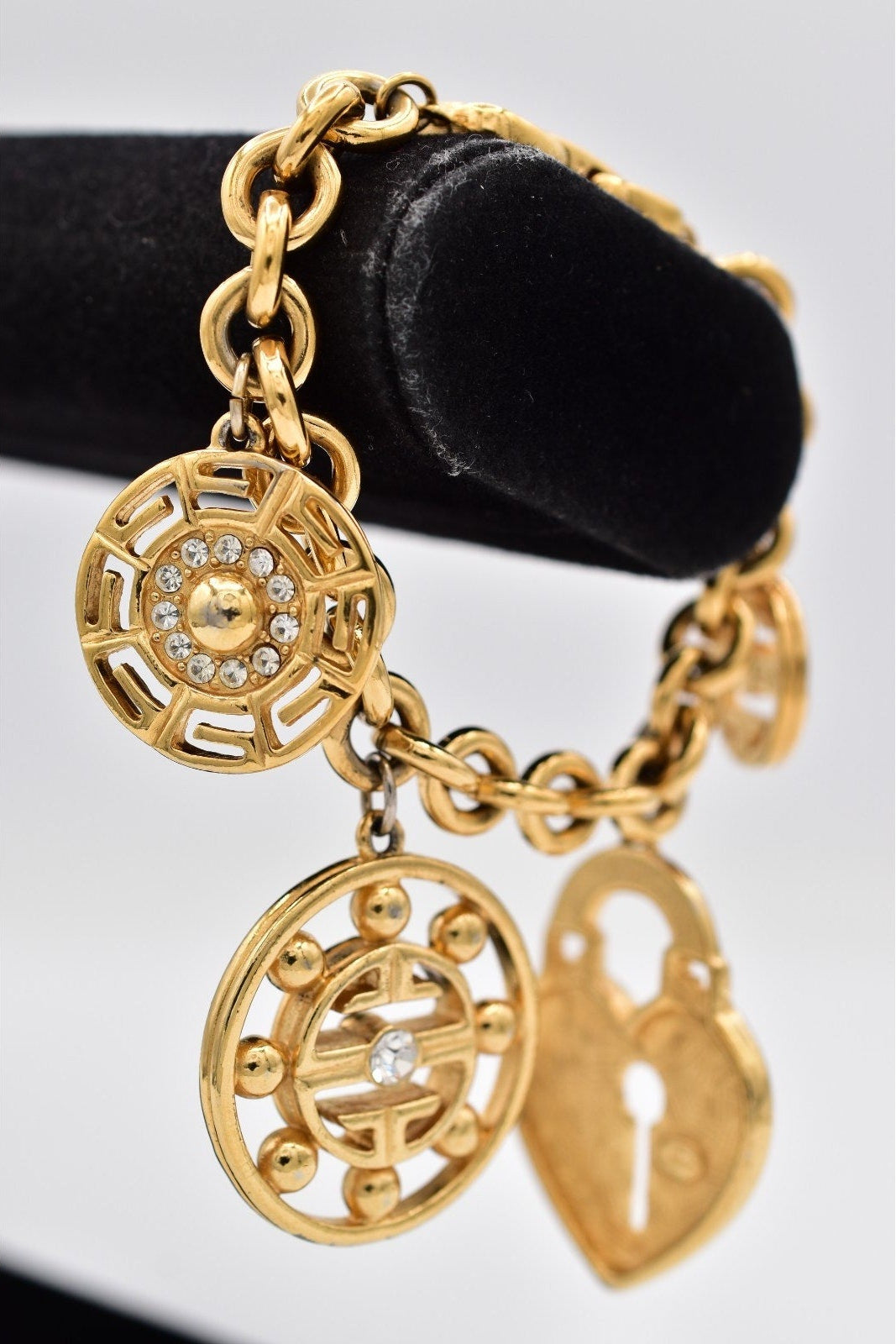 Gold bracelet with charms on a white background