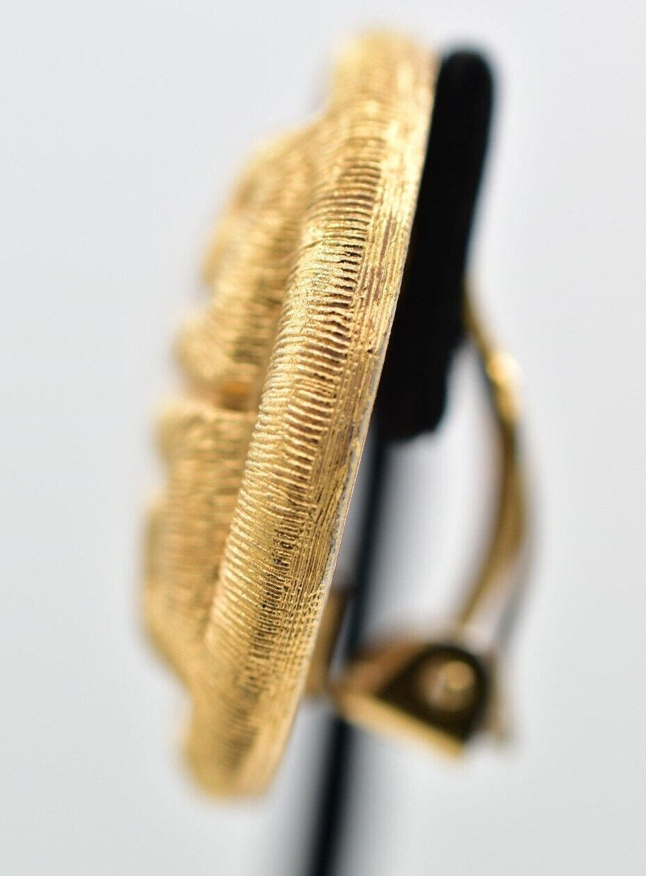 Gold textured circular object on a white background