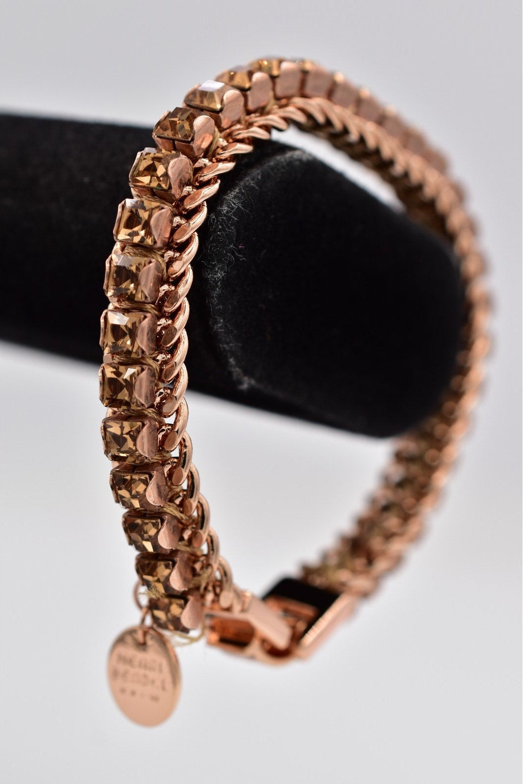 Rose gold bracelet on a light gray background