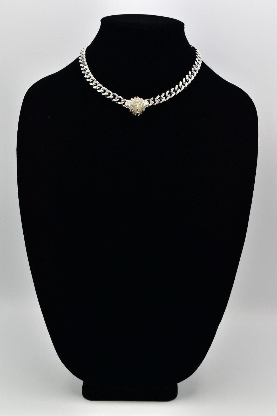 Necklace with a heart-shaped pendant on a black mannequin bust against a white background