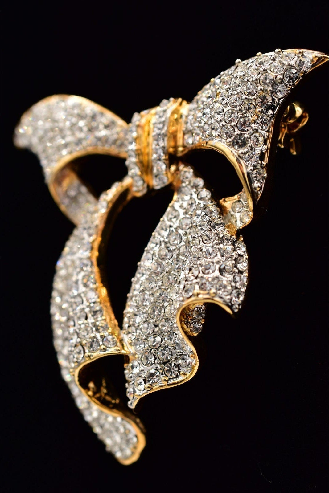 Gold and diamond butterfly-shaped brooch on a black background