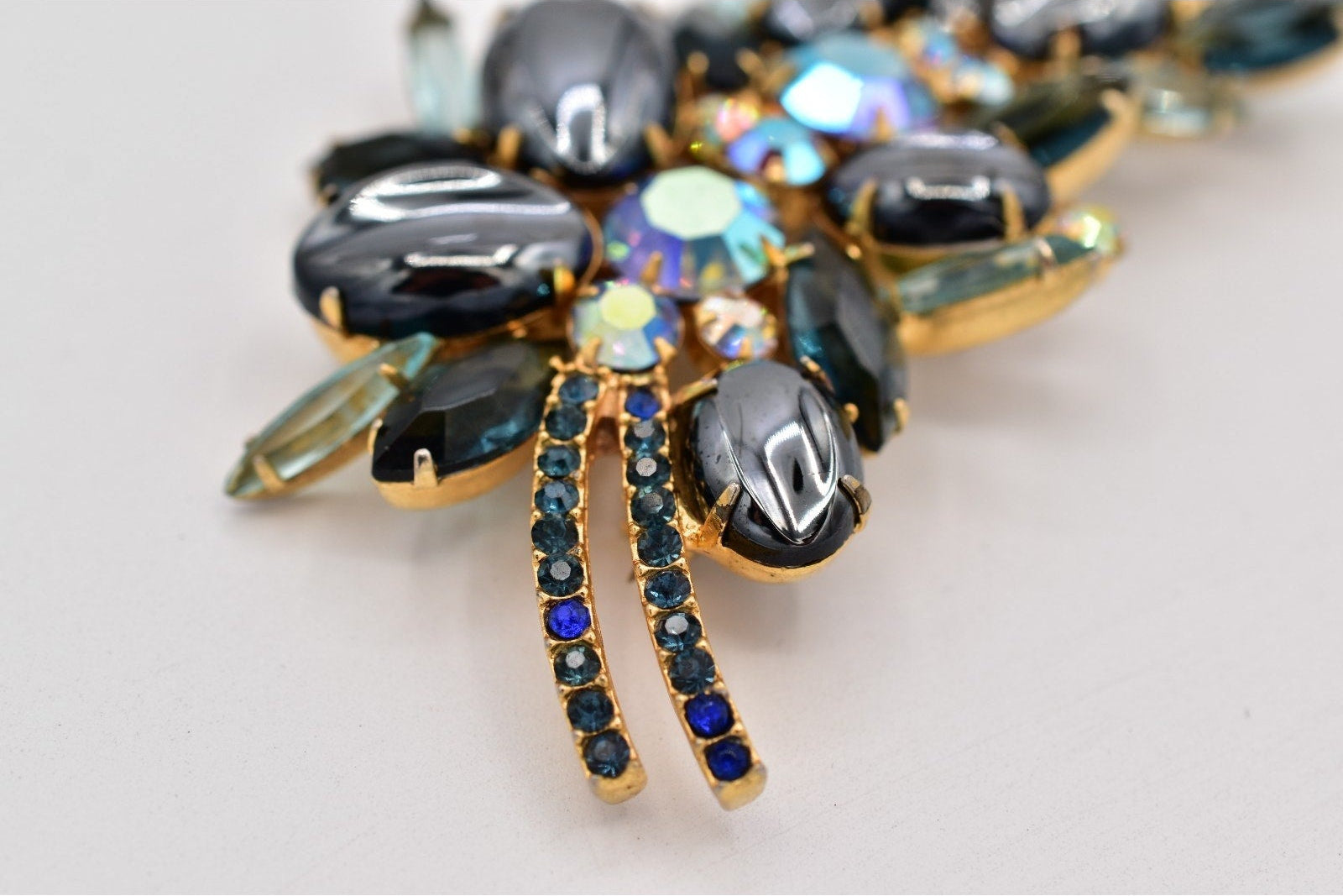 Jewelry piece with multicolored gemstones on a light background