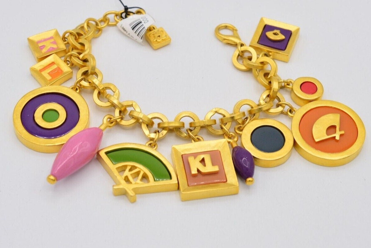 Side view of a New Old Stock with tags Vintage Karl Lagerfeld gold chunky link bracelet with large, colorful pink, green, purple, orange, and red charms showing the iconic hand fan and KL logos laying flat