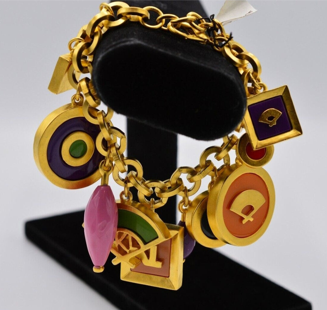 Side view of a New Old Stock with tags Vintage Karl Lagerfeld gold chunky link bracelet with large, colorful pink, green, purple, orange, and red charms showing the iconic hand fan and KL logos
