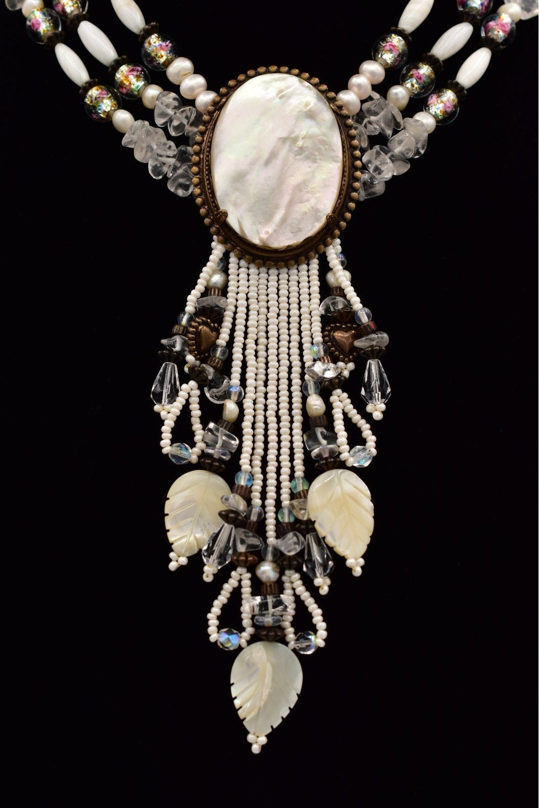 Elegant necklace with beads and shell elements on a black background