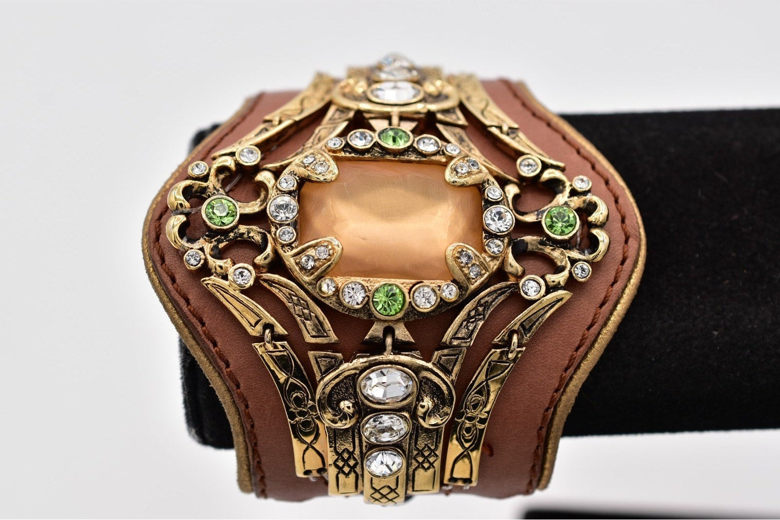 Decorative belt with gold and brown design on a white background