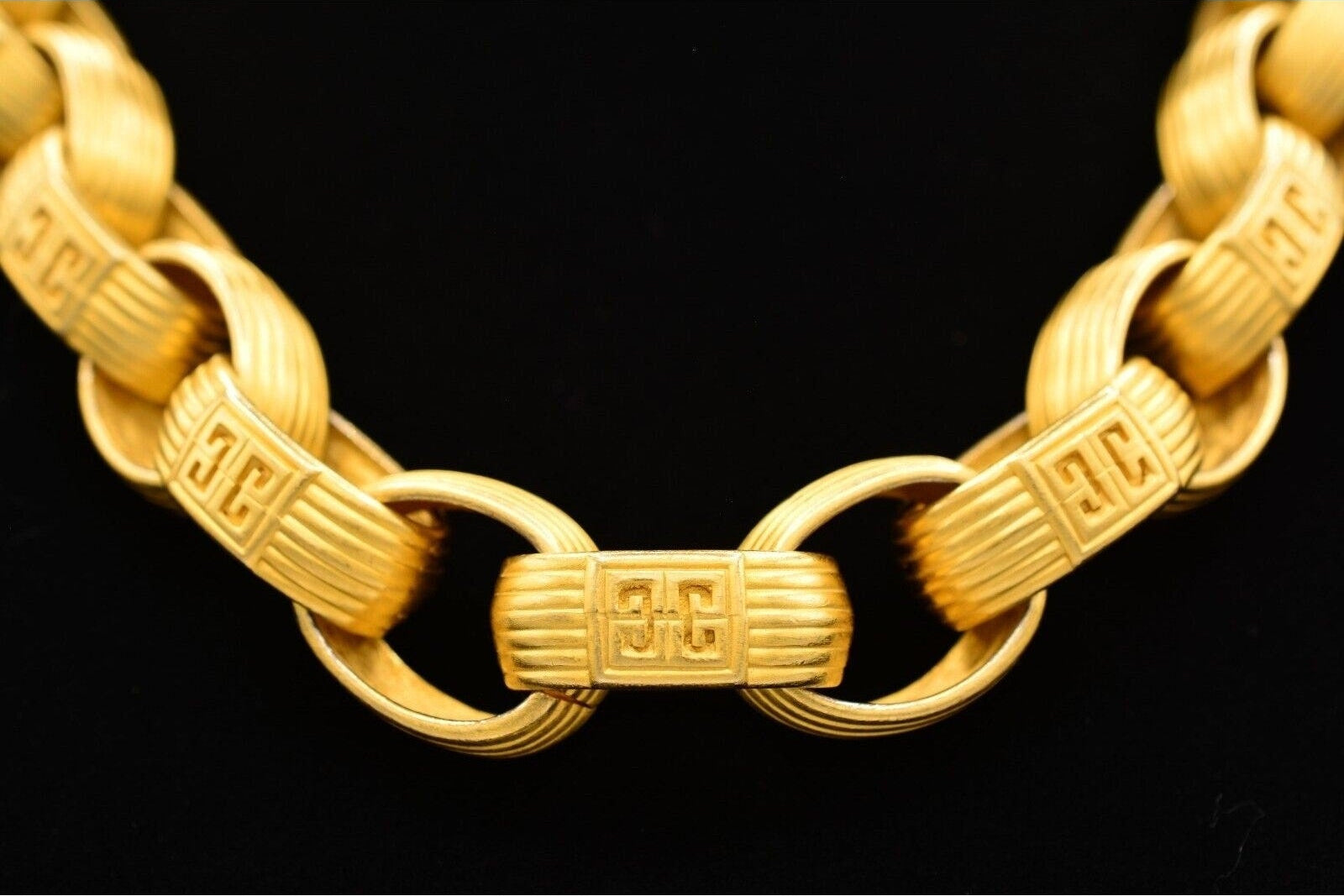 Gold chain bracelet on a black background