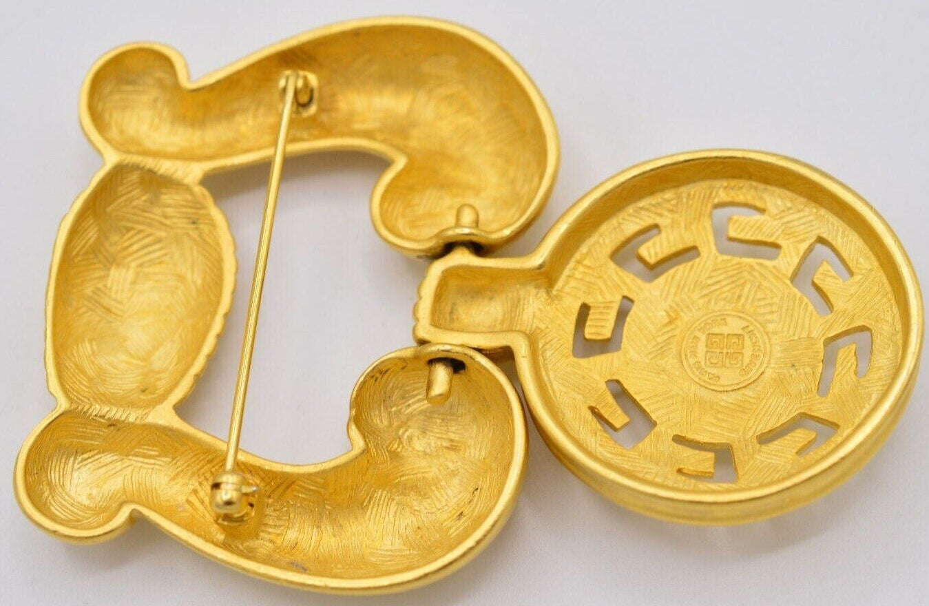 Backside view of a vintage Givenchy door knocker brooch, showing the 4G hallmark