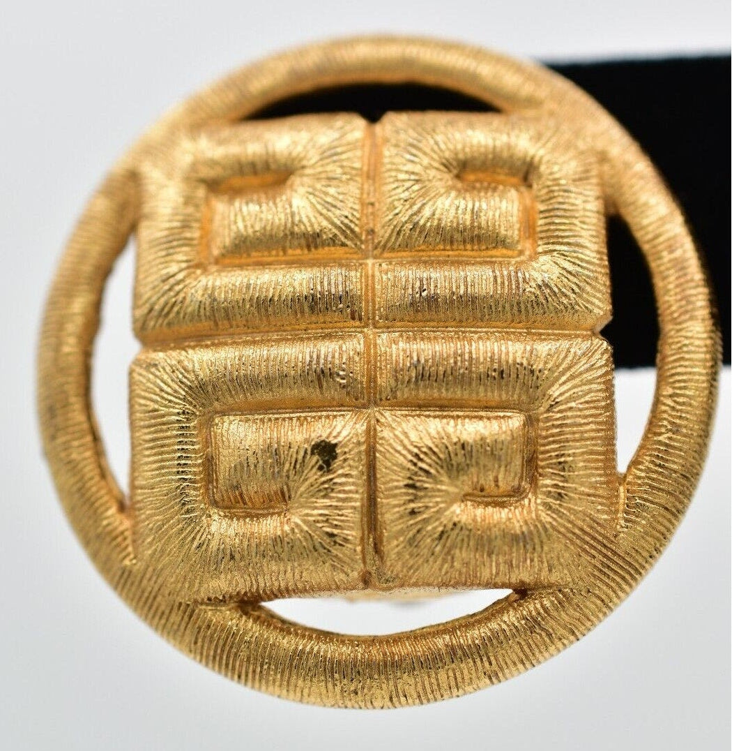 Gold earring with a textured design on a white background