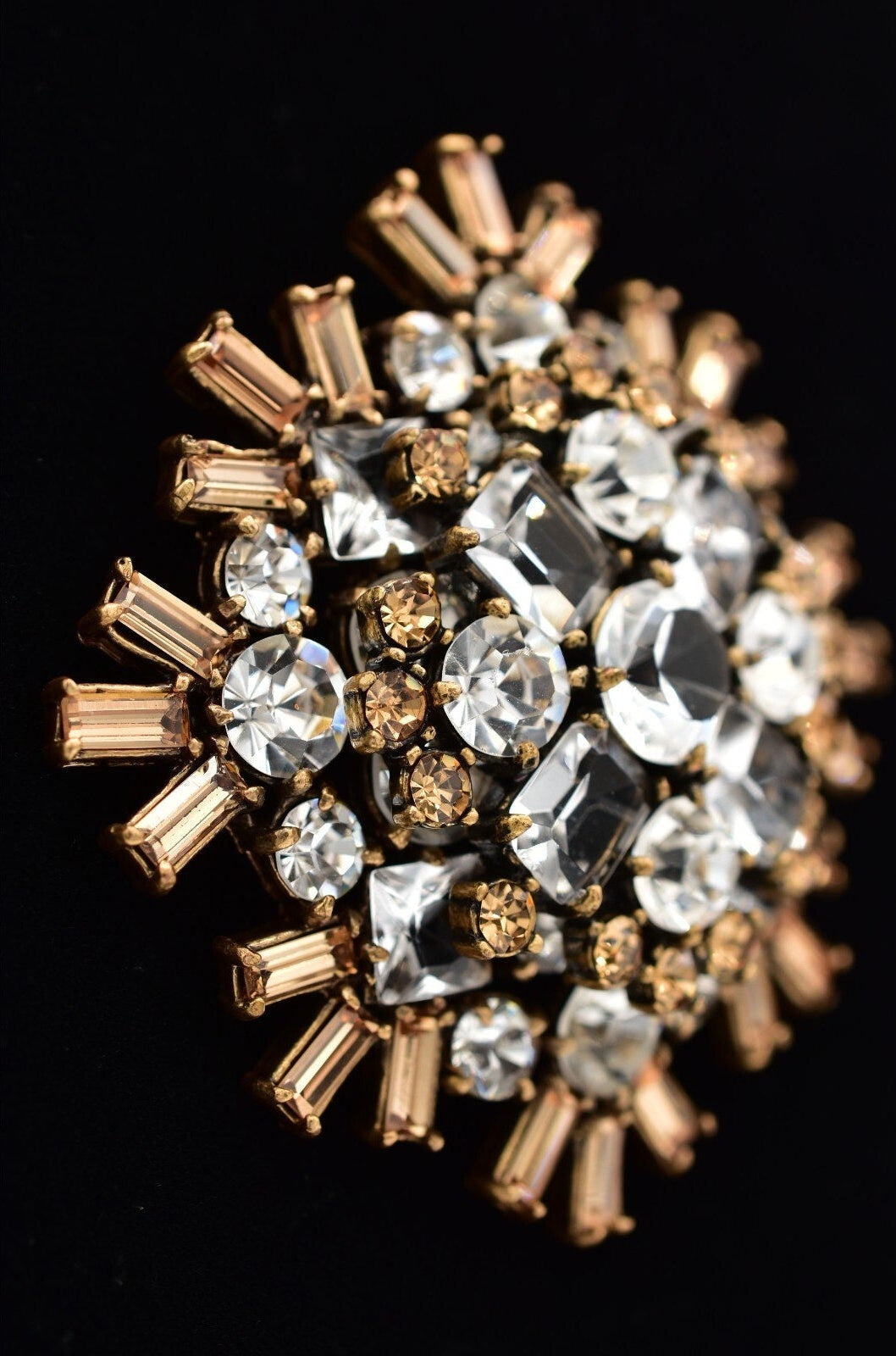 Jewelry with gold and clear gemstones on a black background