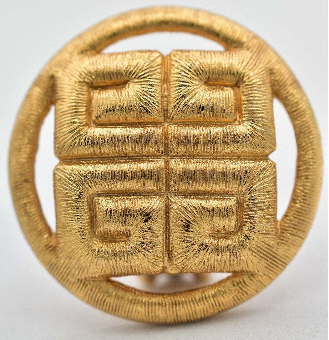 Gold circular earring with textured design on a white background