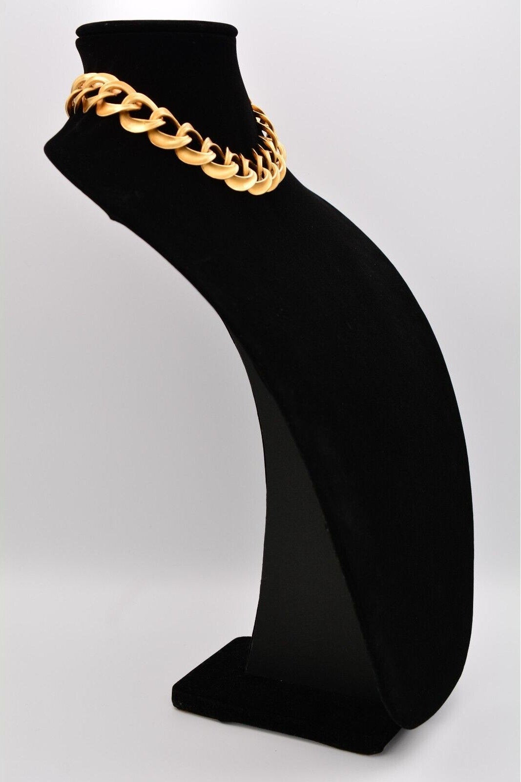 Black sock with a gold chain on a white background