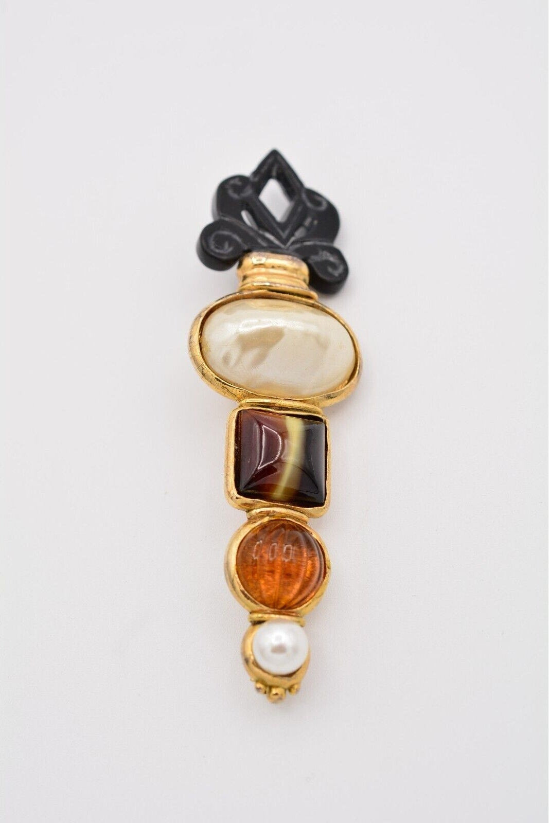 Decorative brooch with gemstones on a white background