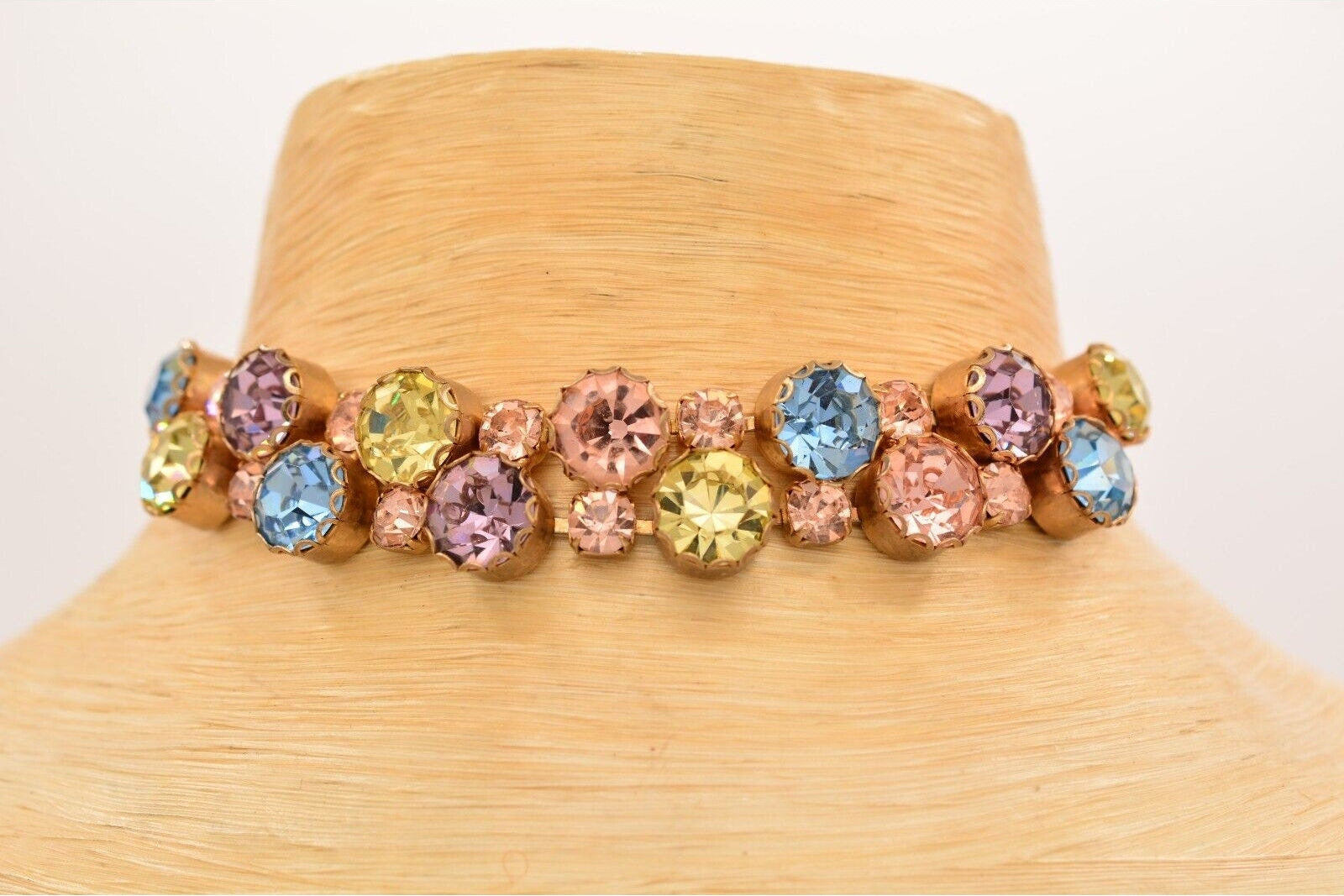 Multicolored gemstone choker on a mannequin neck against a white background